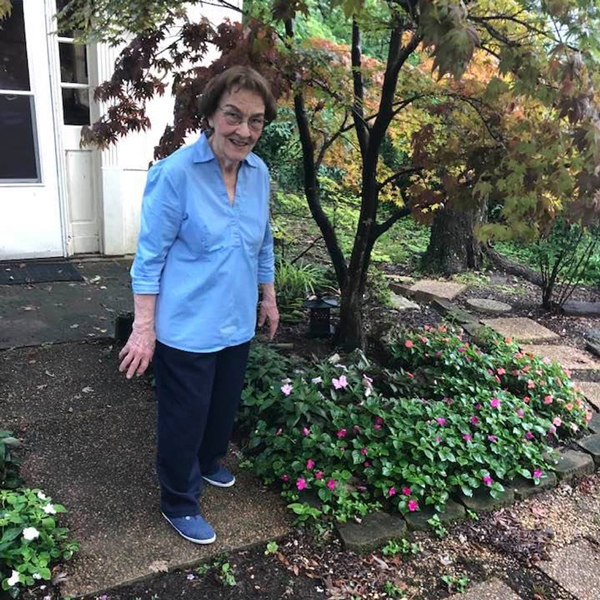 Old women is standing at the door